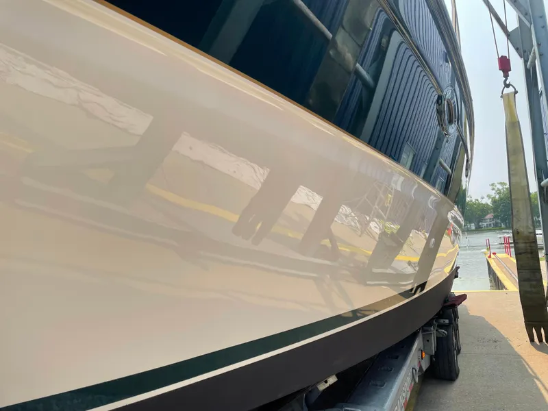 Slide: The Image of Maxum 4200 SCR 2002 boat hull, glossy finish, docked on a trailer. - 11