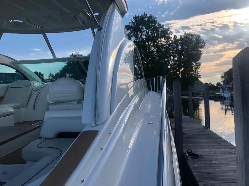 Slide: The Image of 2002 Maxum 4200 SCR yacht docked at sunset, showcasing sleek design and luxury interior. - 15