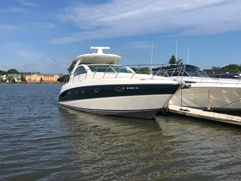 Slide: The Image of 2002 Maxum 4200 SCR yacht docked on a sunny day. - 16