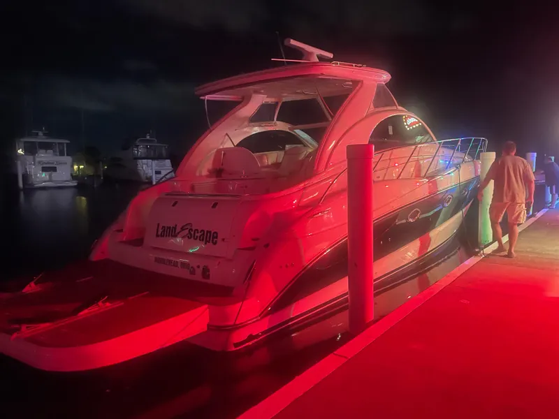 Slide: The Image of Maxum 4200 SCR 2002 yacht docked at night with red lighting. - 5