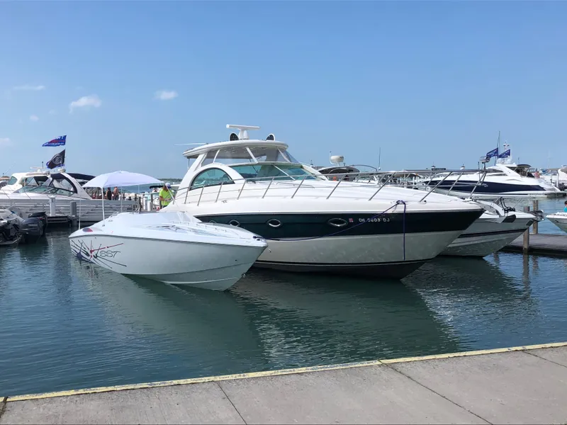 Slide: The Image of 2002 Maxum 4200 SCR yacht docked at marina, clear sky, calm water. - 6