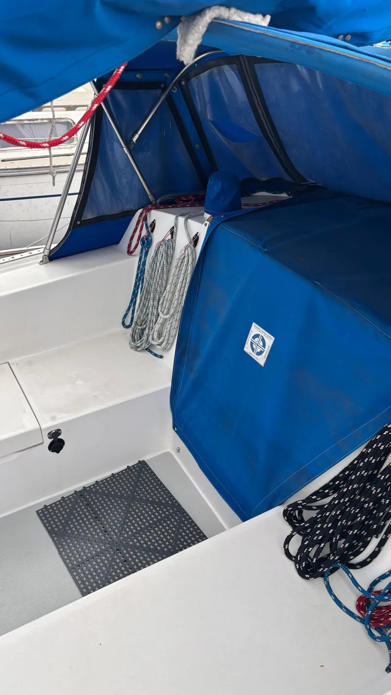 Slide: The Image of 1994 Catalina 36 sailboat cockpit with blue canopy and ropes. - 12