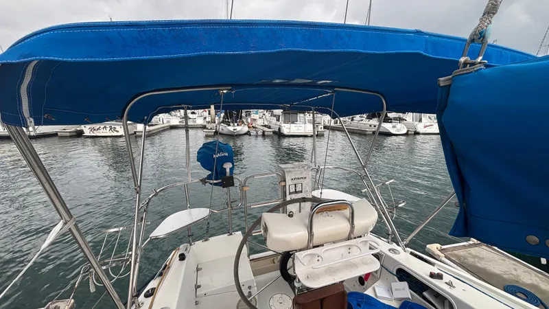 Slide: The Image of 1994 Catalina 36 sailboat with blue canopy docked at marina. - 15