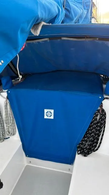 Slide: The Image of 1994 Catalina 36 sailboat cockpit with blue canvas cover and ropes. - 17