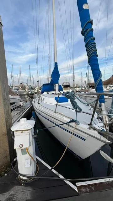 Slide: The Image of 1994 Catalina 36 sailboat docked at marina, blue sail cover, clear sky. - 18