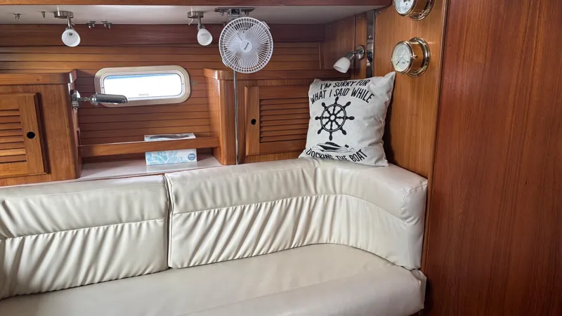 Slide: The Image of Interior of a 1994 Catalina 36 sailboat with cushioned seating and nautical decor. - 21
