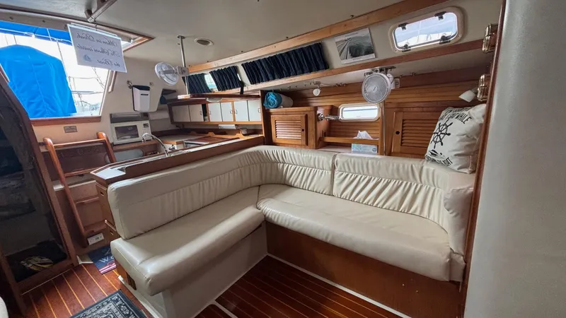 Slide: The Image of Interior of a 1994 Catalina 36 sailboat with cozy seating and wooden accents. - 26