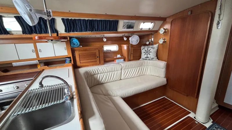 Slide: The Image of Interior of a 1994 Catalina 36 sailboat with cozy seating and wooden finishes. - 27