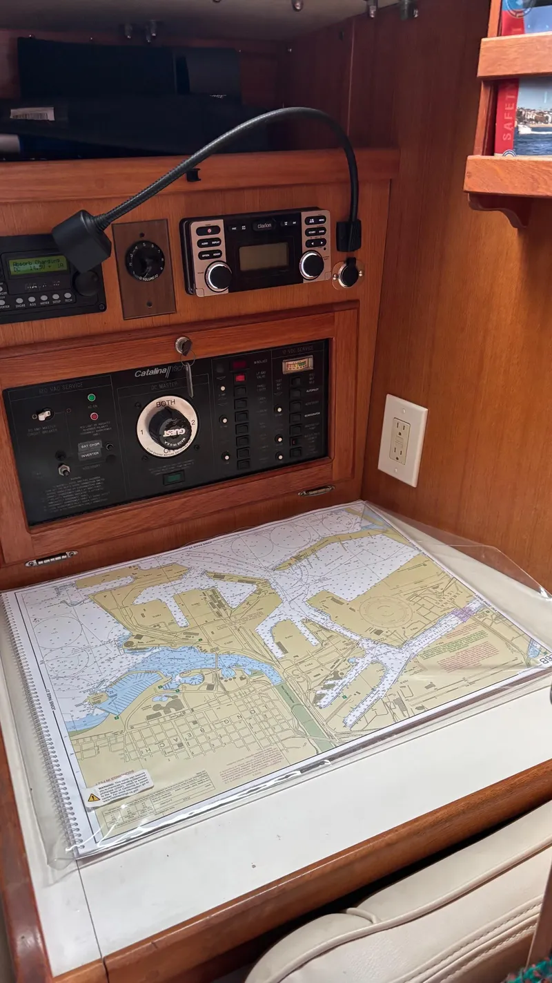 Slide: The Image of Navigation station inside a 1994 Catalina 36 sailboat with chart and radio equipment. - 29