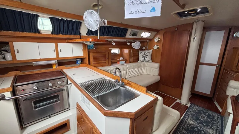 Slide: The Image of Interior of a 1994 Catalina 36 sailboat with kitchen and seating area. - 30