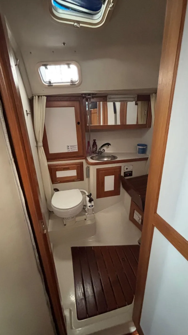 Slide: The Image of Catalina 36 yacht bathroom interior, 1994 model, featuring wooden accents and compact design. - 31