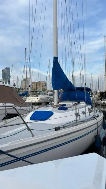 Slide: The Image of 1994 Catalina 36 sailboat docked in marina, blue sail cover, clear sky. - 4