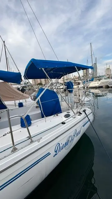 Slide: The Image of 1994 Catalina 36 sailboat docked in marina with blue canopy. - 5