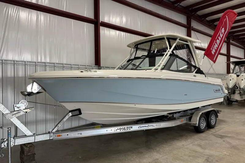 Slide: The Image of 2025 Boston Whaler 240 Vantage boat on trailer in indoor storage facility. - 1