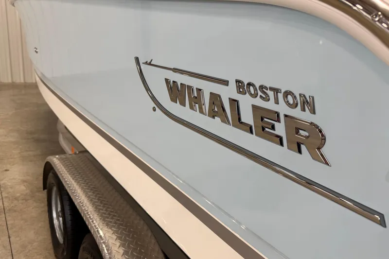 Slide: The Image of 2025 Boston Whaler 240 Vantage boat side view with logo on trailer. - 4