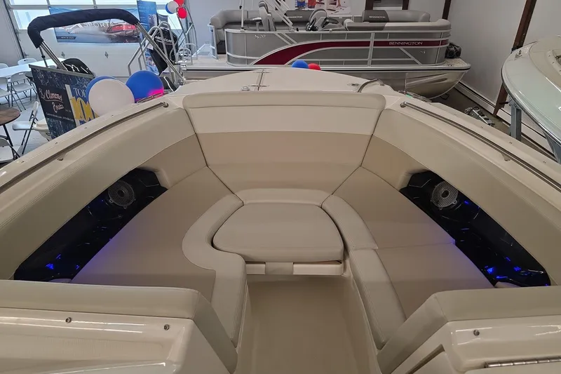 Slide: The Image of 2025 Boston Whaler 240 Vantage boat interior with beige seating and blue accent lighting. - 19