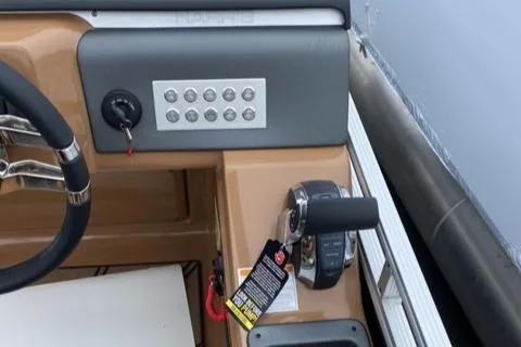 Slide: The Image of 2022 Harris Solstice 230 boat dashboard with steering wheel and control panel. - 11