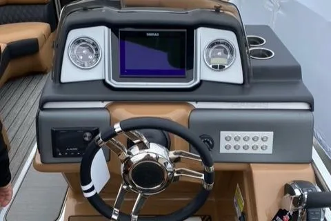 Slide: The Image of 2022 Harris Solstice 230 boat dashboard with steering wheel and digital display. - 12