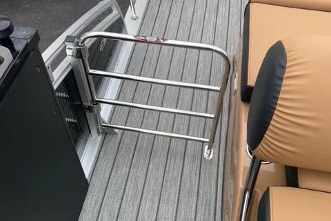 Slide: The Image of 2022 Harris Solstice 230 boat interior with safety gate and cushioned seating. - 16