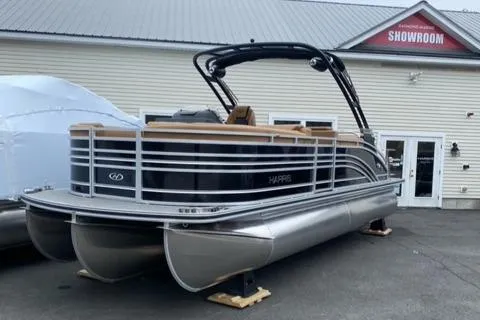 Slide: The Image of 2022 Harris Solstice 230 pontoon boat displayed outside a showroom. - 2