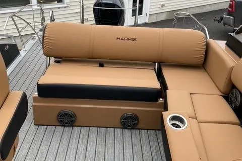 Slide: The Image of 2022 Harris Solstice 230 boat interior with tan seating and built-in speakers. - 28