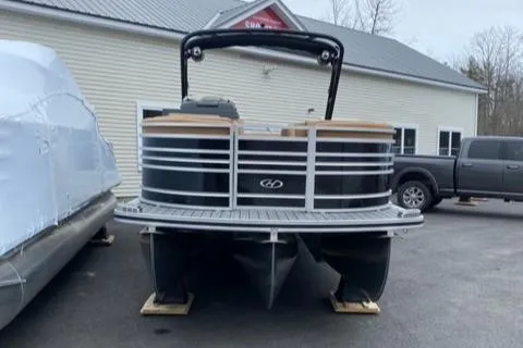 Slide: The Image of 2022 Harris Solstice 230 pontoon boat parked outside a building. - 3