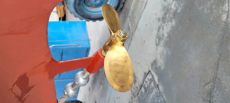 Slide: The Image of 1978 Islander sailboat propeller, brass finish, dockside view. - 6