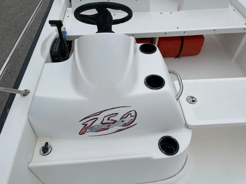 Slide: The Image of 2003 Boston Whaler 150 Sport boat console with steering wheel and cup holders. - 12