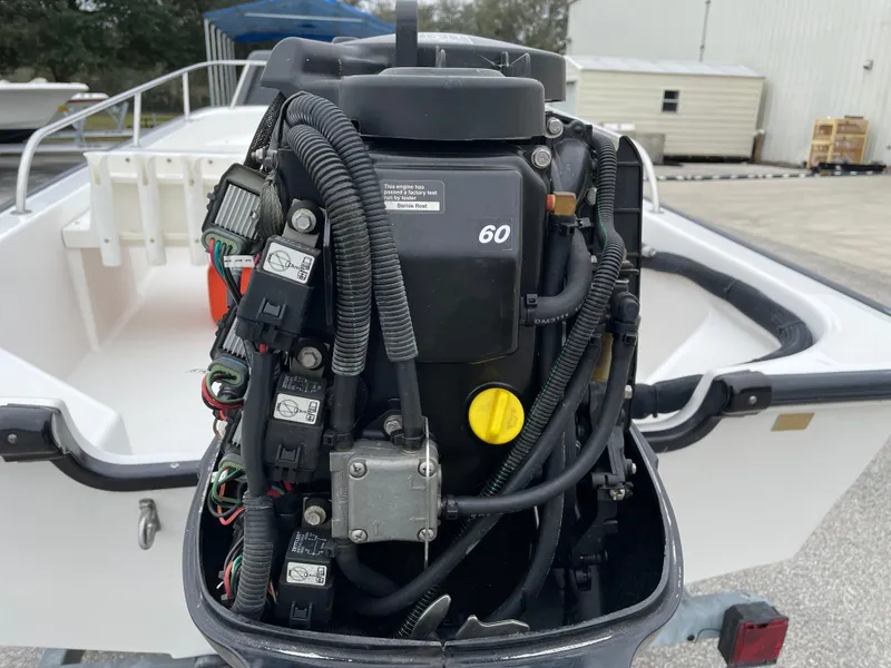 Slide: The Image of 2003 Boston Whaler 150 Sport boat engine, detailed view of motor components. - 18