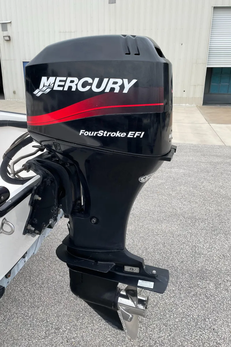 Slide: The Image of Mercury FourStroke EFI outboard motor on 2003 Boston Whaler 150 Sport boat. - 23
