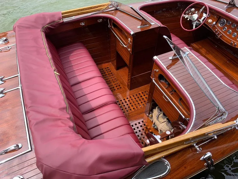 Slide: The Image of Classic 2021 Wilson Watercar with luxurious burgundy leather interior and wooden dashboard. - 10