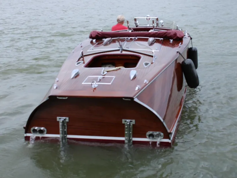 Slide: The Image of Classic 2021 Wilson Watercar on water, showcasing elegant wooden design and sleek features. - 8