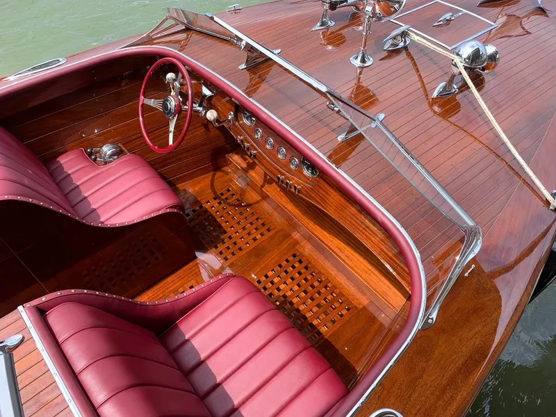 Slide: The Image of Luxurious 2021 Classic Wilson Watercar with polished wood finish and red leather interior. - 9