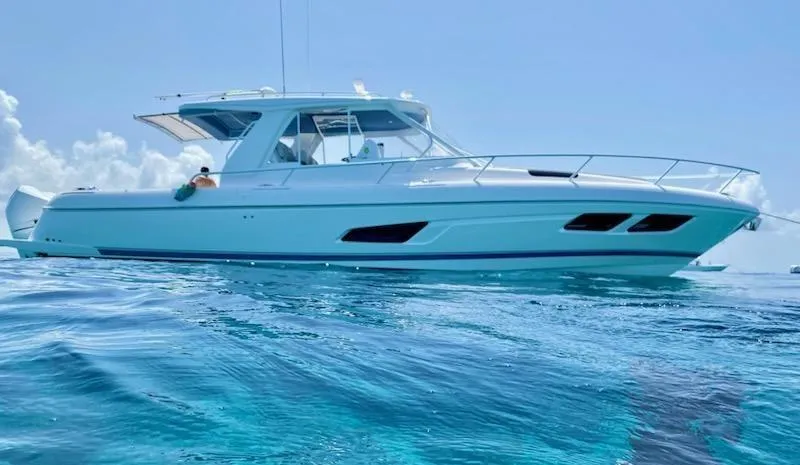 The Image of 2022 Intrepid 438 Evolution yacht on clear blue water under a sunny sky. - 0