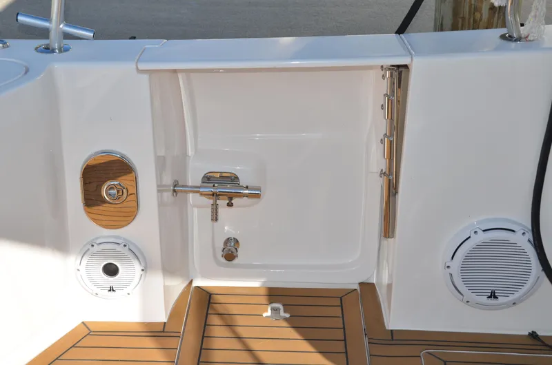 Slide: The Image of 2022 Intrepid 438 Evolution boat deck with teak flooring and marine speakers. - 17