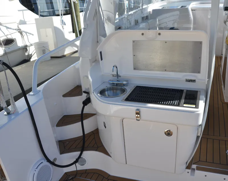 Slide: The Image of Outdoor kitchenette on 2022 Intrepid 438 Evolution yacht with sink and grill. - 19