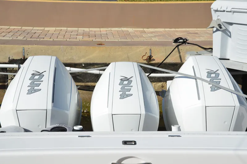 Slide: The Image of Triple outboard engines on a 2022 Intrepid 438 Evolution boat docked. - 21