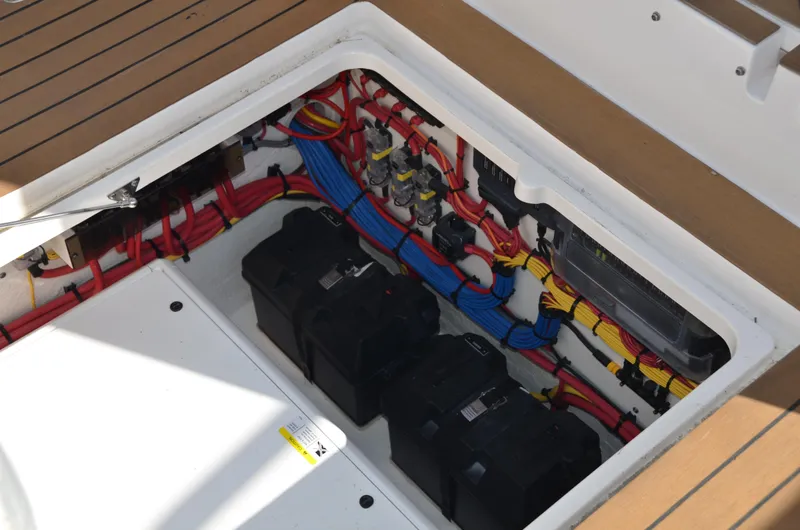 Slide: The Image of Electrical compartment of 2022 Intrepid 438 Evolution boat with organized wiring and batteries. - 26