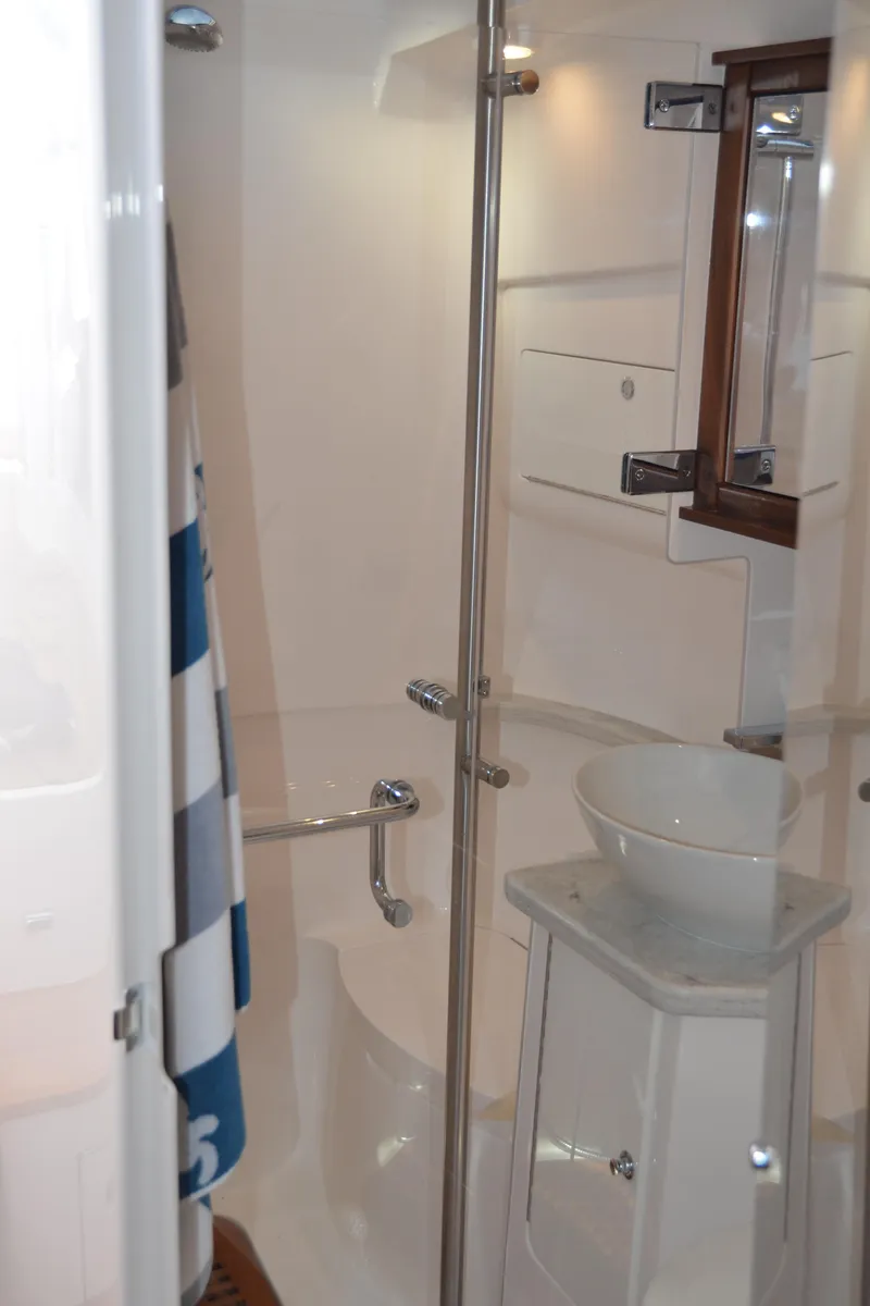 Slide: The Image of 2022 Intrepid 438 Evolution yacht bathroom with modern fixtures and glass shower enclosure. - 31
