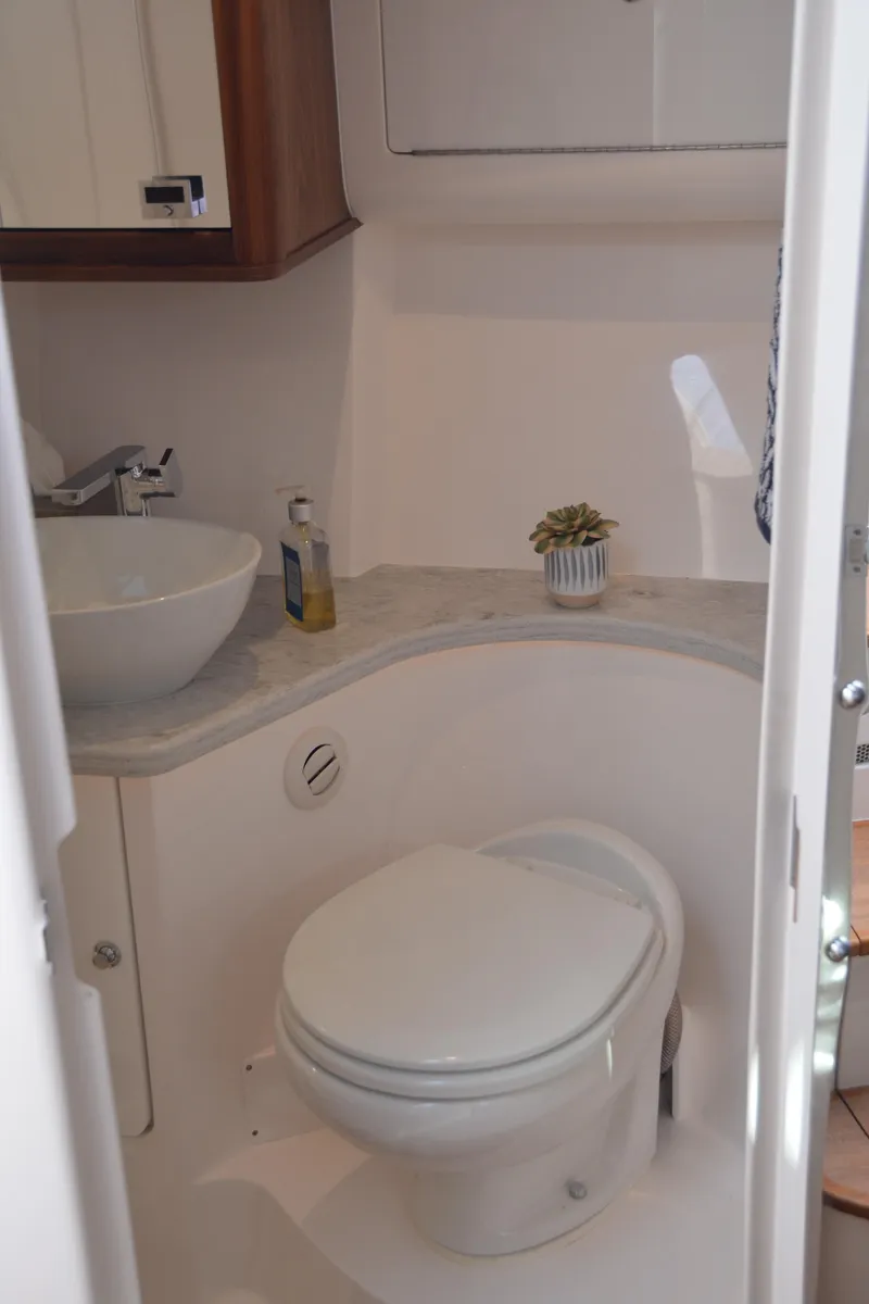 Slide: The Image of 2022 Intrepid 438 Evolution yacht bathroom with modern fixtures and compact design. - 32