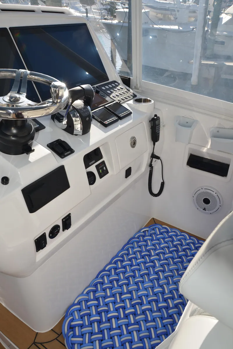 Slide: The Image of Helm of 2022 Intrepid 438 Evolution boat with modern controls and blue mat. - 6