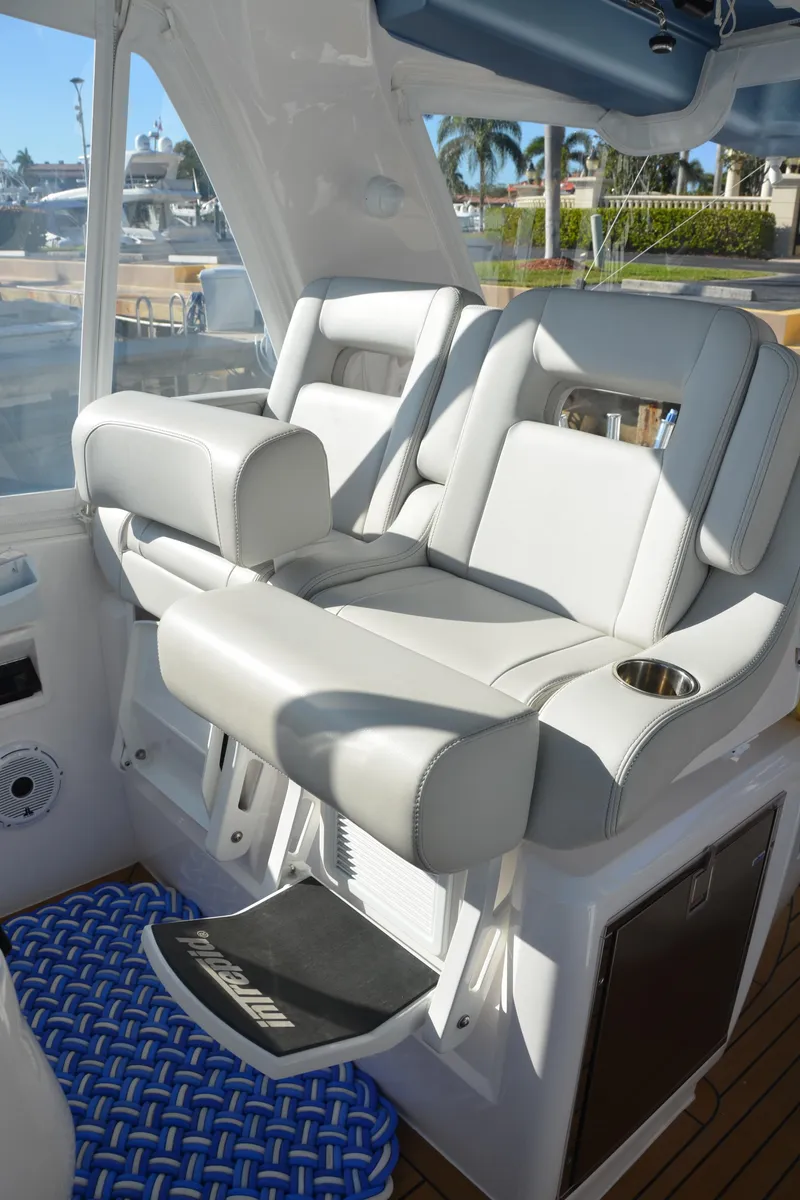 Slide: The Image of Luxury seating on 2022 Intrepid 438 Evolution yacht, featuring plush white upholstery and modern design. - 8