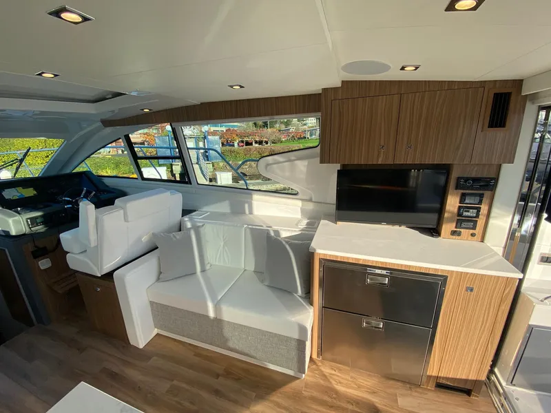 Slide: The Image of Interior of 2025 Cruisers Yachts 46 Cantius with modern seating and cabinetry. - 24