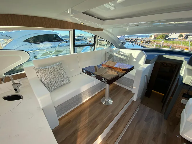 Slide: The Image of Luxurious interior of 2025 Cruisers Yachts 46 Cantius with elegant seating and table. - 27
