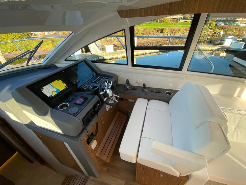 Slide: The Image of 2025 Cruisers Yachts 46 Cantius helm with modern navigation system and plush seating. - 30