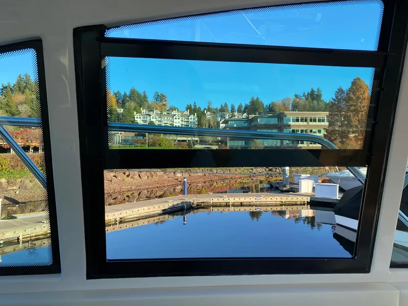 Slide: The Image of View from 2025 Cruisers Yachts 46 Cantius, overlooking marina and waterfront buildings. - 32