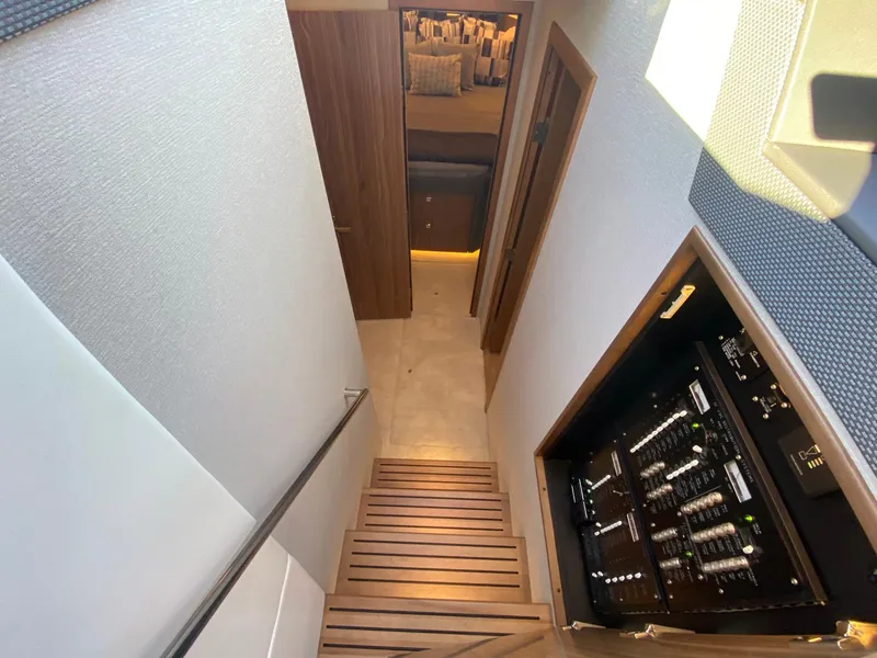 Slide: The Image of Interior view of 2025 Cruisers Yachts 46 Cantius, featuring a staircase and control panel. - 37