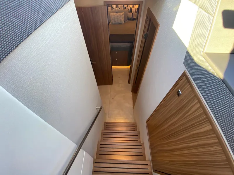 Slide: The Image of Interior staircase of 2025 Cruisers Yachts 46 Cantius, featuring modern wood design. - 38