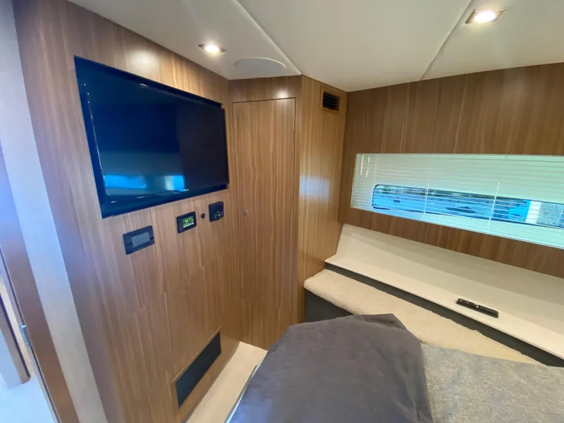 Slide: The Image of Interior of 2025 Cruisers Yachts 46 Cantius with TV and modern wood paneling. - 43