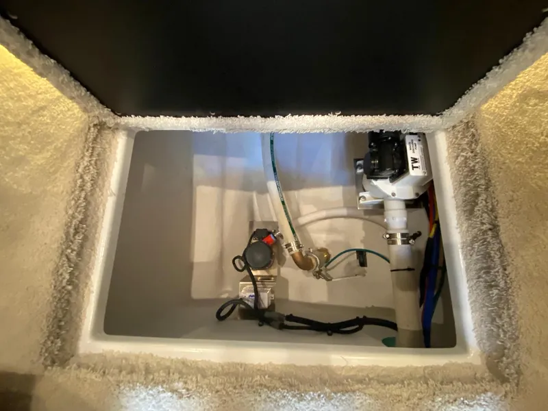 Slide: The Image of 2025 Cruisers Yachts 46 Cantius engine compartment with visible plumbing and wiring. - 46